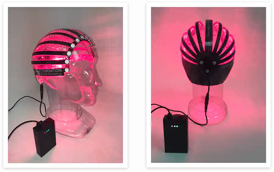 Foundation Light Therapy laser cap shown illuminated from the side and back during use.