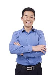 Portrait of a smiling man standing with his arms crossed.