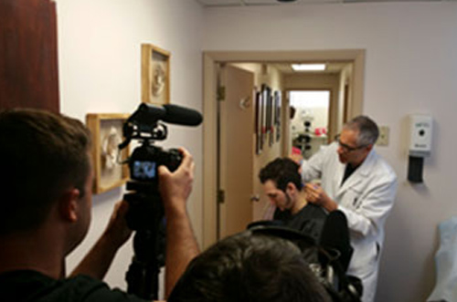 Dr. Jeffrey Epstein, Miami board-certified facial plastic surgeon, demonstrating a hair restoration procedure during a video recording