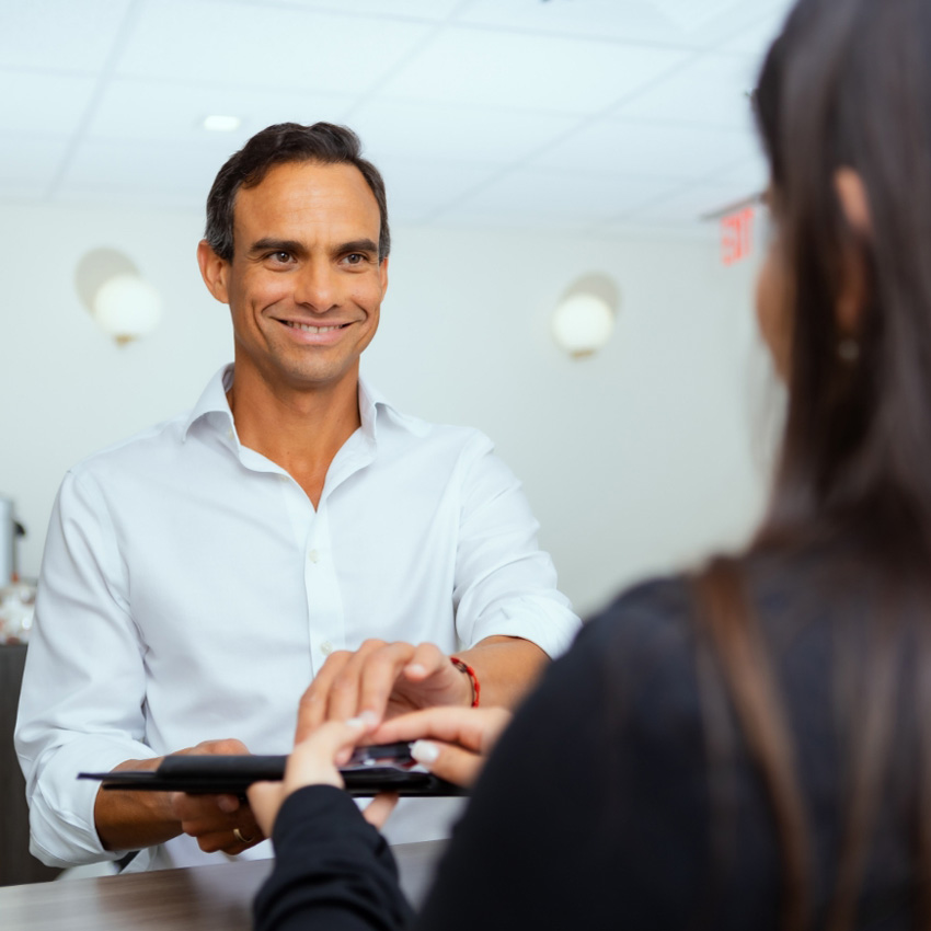 Patient checking in with a member of Dr. Jeffrey Epstein's team.