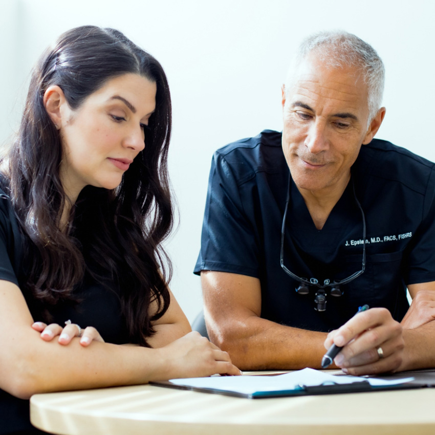 Dr. Jeffrey Epstein, Miami board-certified facial plastic surgeon, reviewing treatment plans with a member of his clinical team.