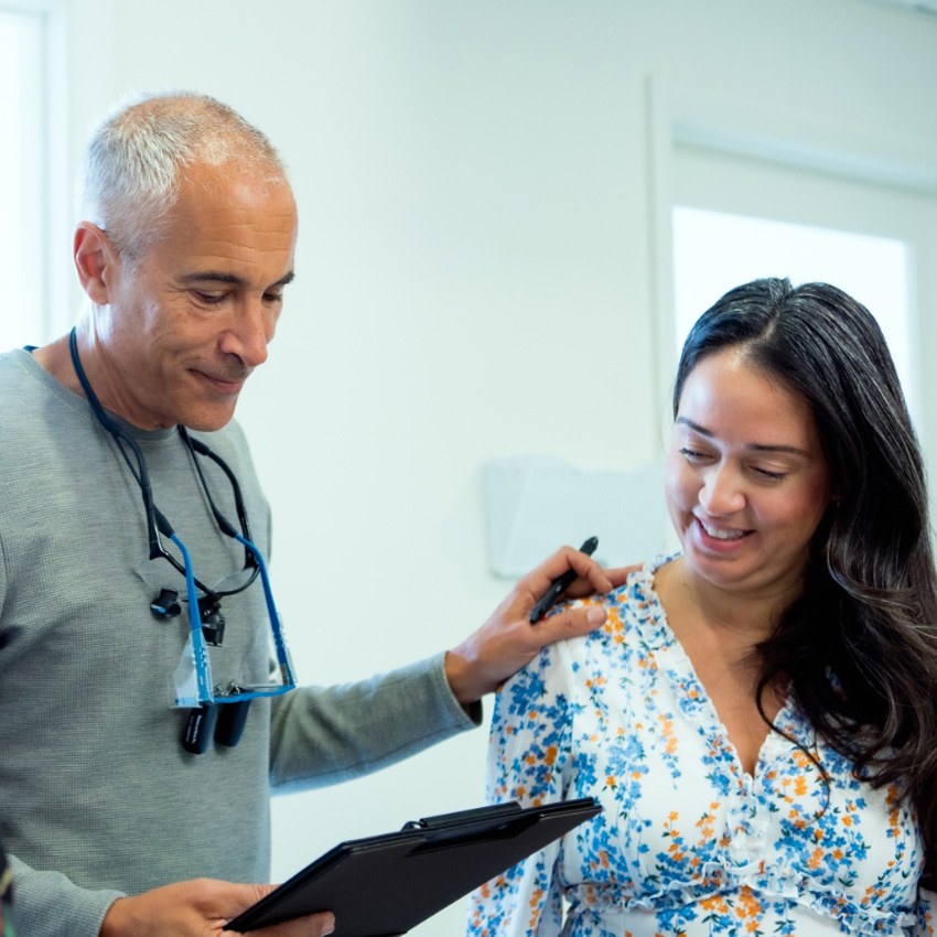Dr. Jeffrey Epstein, Miami board-certified facial plastic surgeon, reviewing treatment information with a patient during a consultation.
