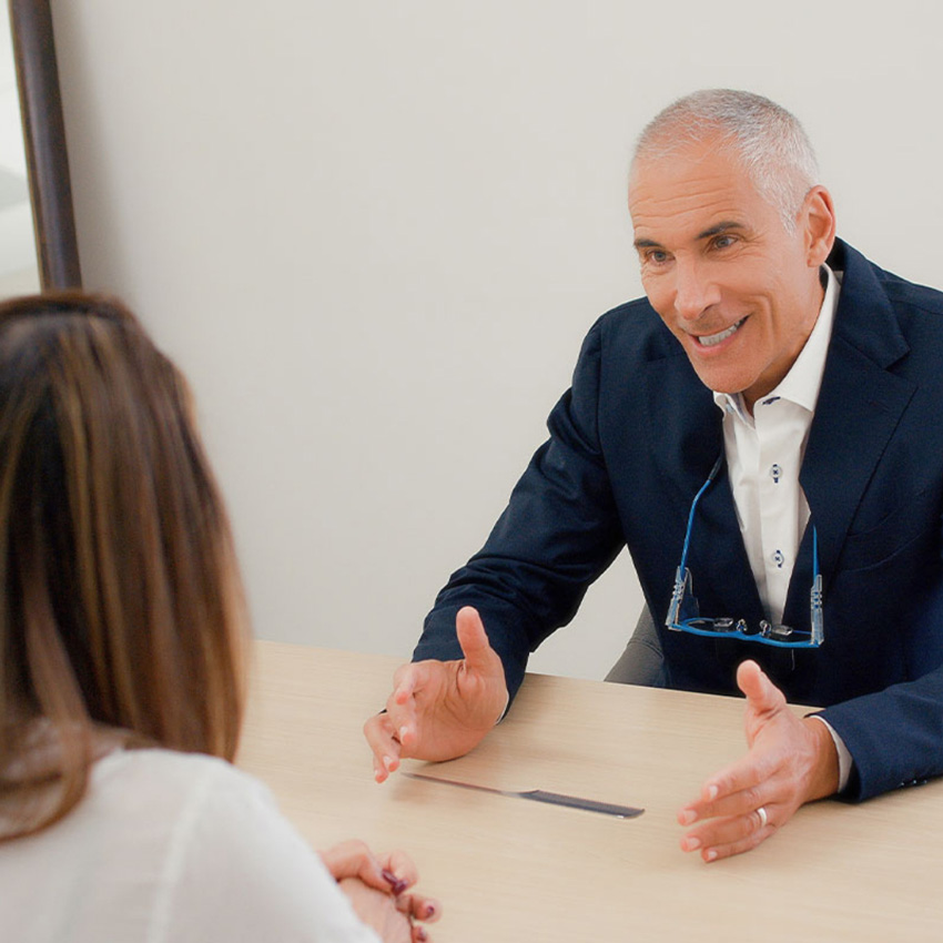 Dr. Jeffrey Epstein, Miami board-certified facial plastic surgeon, speaking with a patient during a one-on-one consultation.