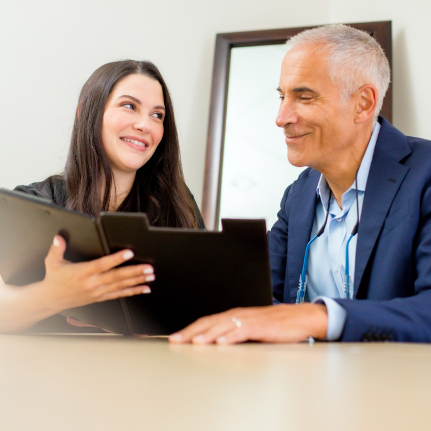Dr. Jeffrey Epstein, Miami board-certified facial plastic surgeon, reviewing treatment plans with a member of his clinical team.