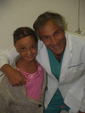Dr. Jeffrey Epstein, Miami board-certified facial plastic surgeon, posing with a young patient following a pediatric hair restoration procedure.