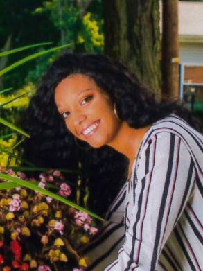 Young woman with restored hair posing outdoors with long, healthy hair growth.
