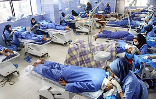 Large hair transplant clinic with multiple patients undergoing procedures simultaneously.